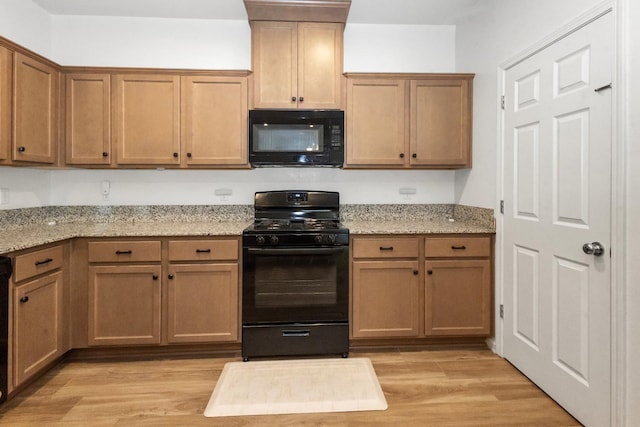 17 Medieval, Merced, CA 95341 - kitchen with black appliances, light wood-style floors, and light stone countertops