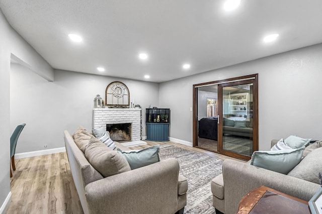 42 W Rall Ave, Clovis, CA 93612 - living room with light wood-style flooring, recessed lighting, and a brick fireplace