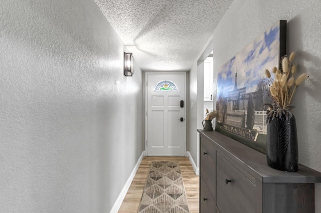 42 W Rall Ave, Clovis, CA 93612 - doorway with a textured wall, a textured ceiling, and light wood finished floors
