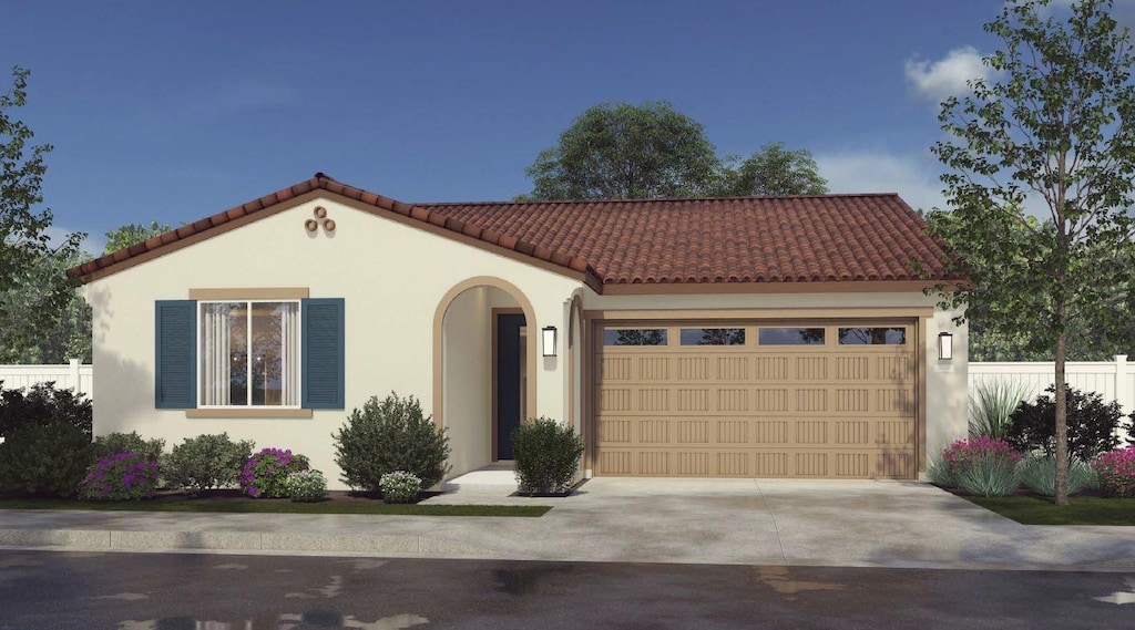 1443 Bloom Ln, Clovis, CA 93619 - mediterranean / spanish home featuring an attached garage, a tiled roof, driveway, and stucco siding
