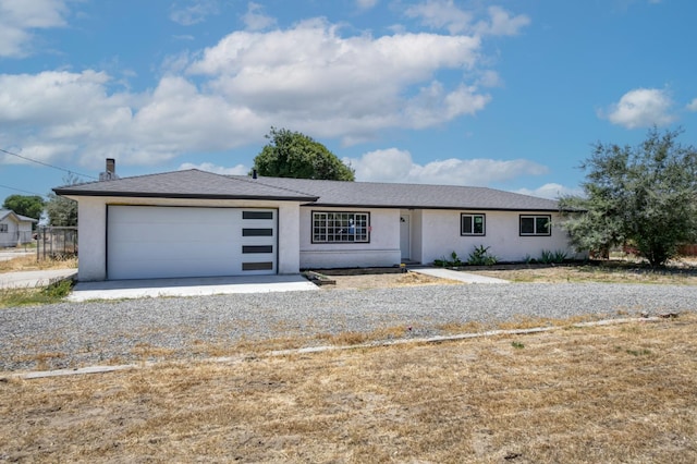 17189 Iona Ave, Lemoore, CA 93245 - ranch-style house featuring an attached garage, stucco siding, and driveway