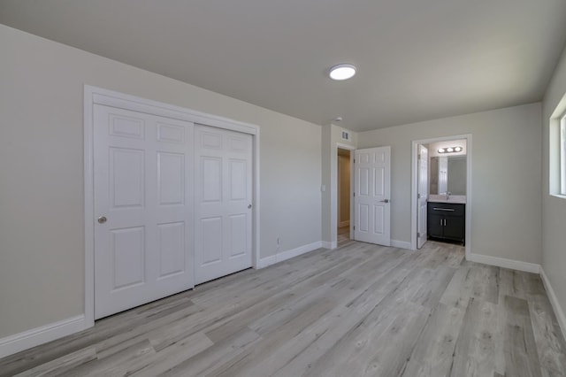 17189 Iona Ave, Lemoore, CA 93245 - unfurnished bedroom featuring light wood-style flooring, a closet, and ensuite bathroom