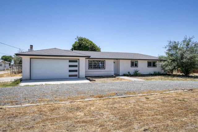 17189 Iona Ave, Lemoore, CA 93245 - single story home featuring an attached garage, stucco siding, and gravel driveway