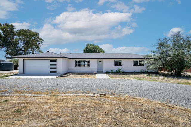 17189 Iona Ave, Lemoore, CA 93245 - ranch-style home featuring stucco siding, an attached garage, and concrete driveway