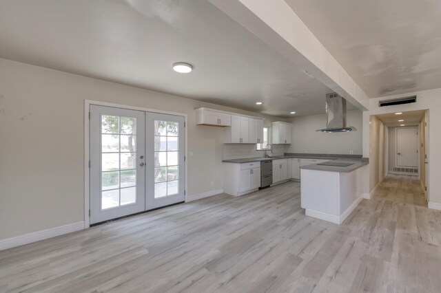 17189 Iona Ave, Lemoore, CA 93245 - kitchen featuring wall chimney range hood, dishwasher, french doors, a peninsula, and light wood-style flooring