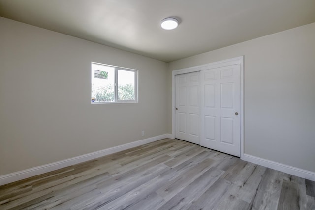 17189 Iona Ave, Lemoore, CA 93245 - unfurnished bedroom featuring light wood finished floors and a closet