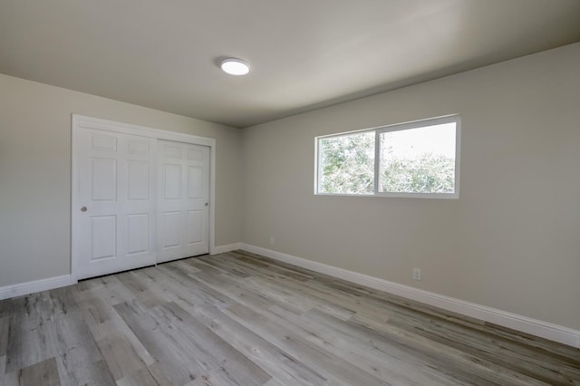 17189 Iona Ave, Lemoore, CA 93245 - unfurnished bedroom with light wood-type flooring and a closet