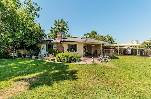 5432 E Swift Ave, Fresno, CA 93727 - back of house with a patio area, roof mounted solar panels, a chimney, a ceiling fan, and stucco siding