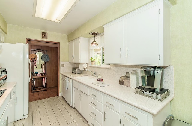 5432 E Swift Ave, Fresno, CA 93727 - kitchen featuring white appliances, white cabinetry, light countertops, and hanging light fixtures