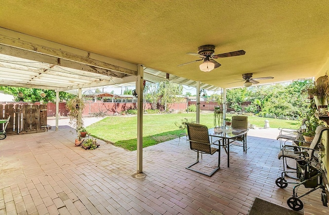 5432 E Swift Ave, Fresno, CA 93727 - fenced backyard with a patio area, outdoor dining space, and a ceiling fan
