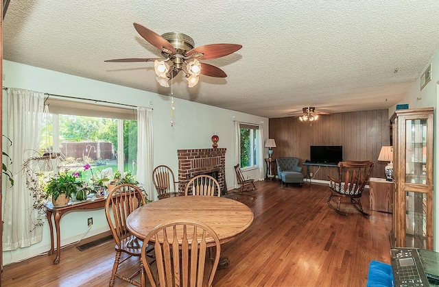 5432 E Swift Ave, Fresno, CA 93727 - dining room with ceiling fan, wood finished floors, wooden walls, and a textured ceiling