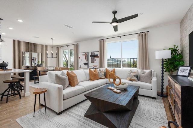 1473 Bloom Ln, Clovis, CA 93619 - living room with light wood-style floors, a ceiling fan, a chandelier, and recessed lighting