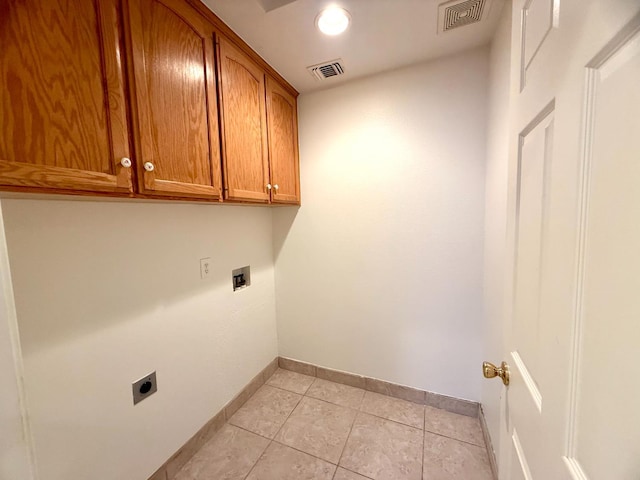 4688 W Weldon Ave, Fresno, CA 93722 - laundry room with cabinet space, electric dryer hookup, light tile patterned flooring, and washer hookup