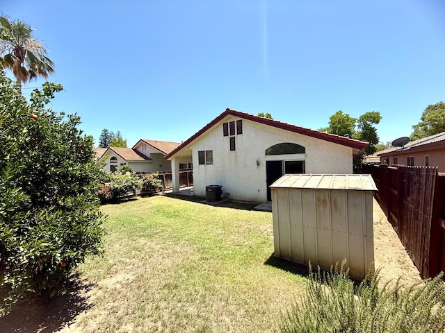 4688 W Weldon Ave, Fresno, CA 93722 - rear view of house featuring stucco siding and a storage unit