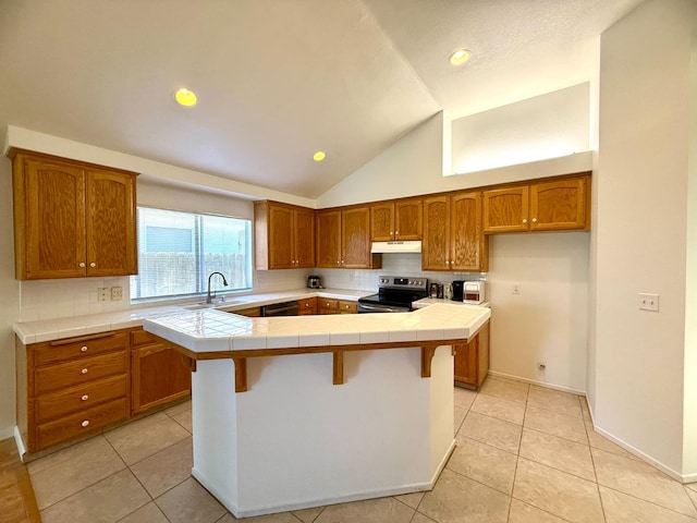 4688 W Weldon Ave, Fresno, CA 93722 - kitchen featuring stainless steel electric stove, tile counters, brown cabinets, under cabinet range hood, and decorative backsplash