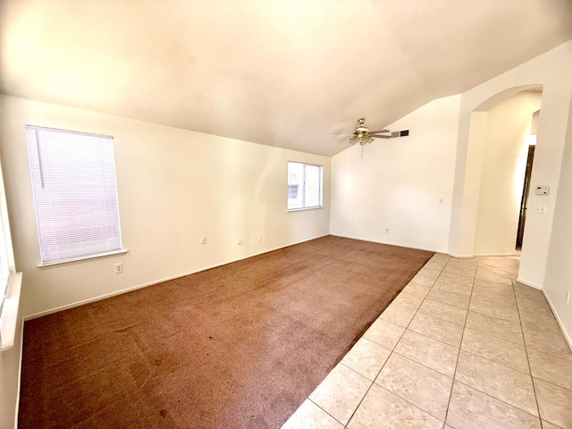 4688 W Weldon Ave, Fresno, CA 93722 - spare room featuring arched walkways, a ceiling fan, lofted ceiling, light tile patterned flooring, and light colored carpet