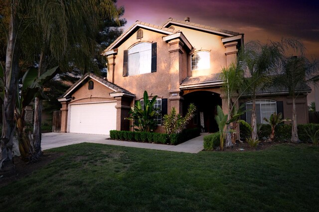 10080 N Dearing Ave, Fresno, CA 93730 - mediterranean / spanish-style house with stucco siding, driveway, a front yard, and a tile roof