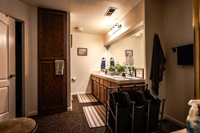 10080 N Dearing Ave, Fresno, CA 93730 - full bathroom with double vanity and a textured ceiling