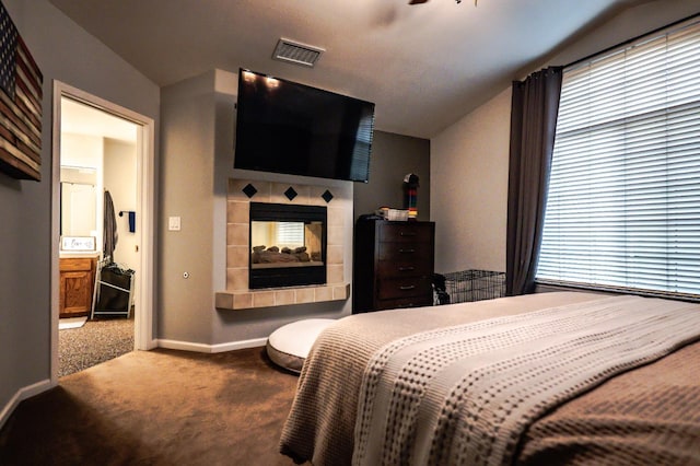10080 N Dearing Ave, Fresno, CA 93730 - bedroom with carpet floors, vaulted ceiling, and a tile fireplace