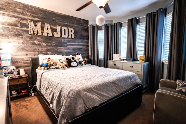 10080 N Dearing Ave, Fresno, CA 93730 - carpeted bedroom with wood walls and a ceiling fan