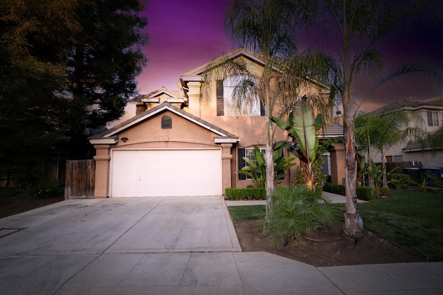 10080 N Dearing Ave, Fresno, CA 93730 - mediterranean / spanish home featuring stucco siding, concrete driveway, and an attached garage