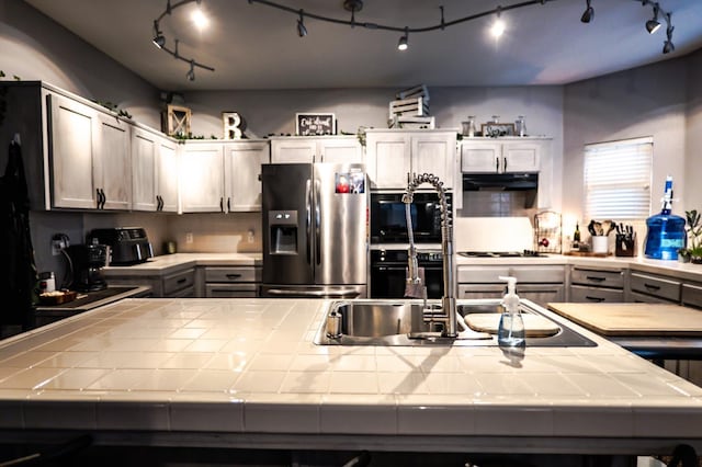 10080 N Dearing Ave, Fresno, CA 93730 - kitchen featuring stainless steel fridge, tile countertops, under cabinet range hood, and track lighting
