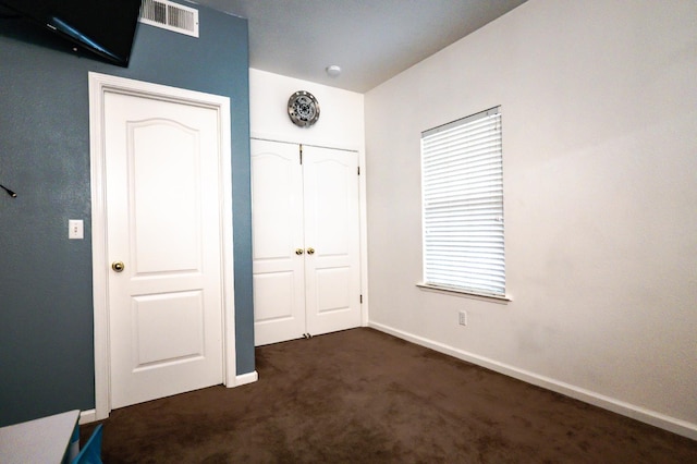 10080 N Dearing Ave, Fresno, CA 93730 - unfurnished bedroom featuring dark carpet and a closet