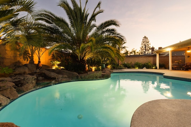 1199 E Cole Ave, Fresno, CA 93720 - pool at dusk featuring a fenced backyard and a patio