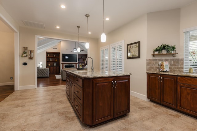 1199 E Cole Ave, Fresno, CA 93720 - kitchen with ceiling fan, light stone counters, pendant lighting, recessed lighting, and open floor plan