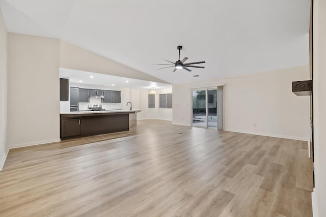 2540 E Seeger Ave, Visalia, CA 93292 - unfurnished living room featuring ceiling fan, vaulted ceiling, light wood-style flooring, and recessed lighting