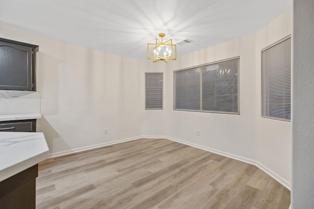2540 E Seeger Ave, Visalia, CA 93292 - unfurnished dining area featuring a chandelier and light wood-style floors