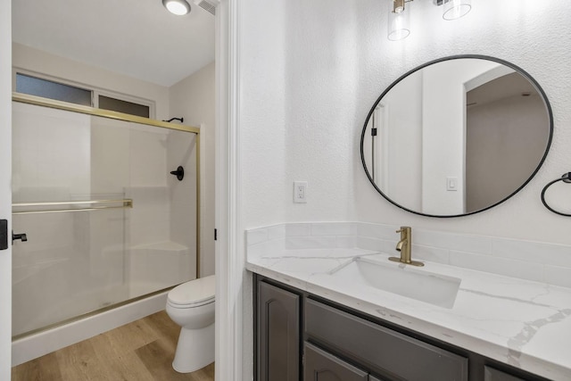 2540 E Seeger Ave, Visalia, CA 93292 - bathroom featuring a stall shower, vanity, and wood finished floors