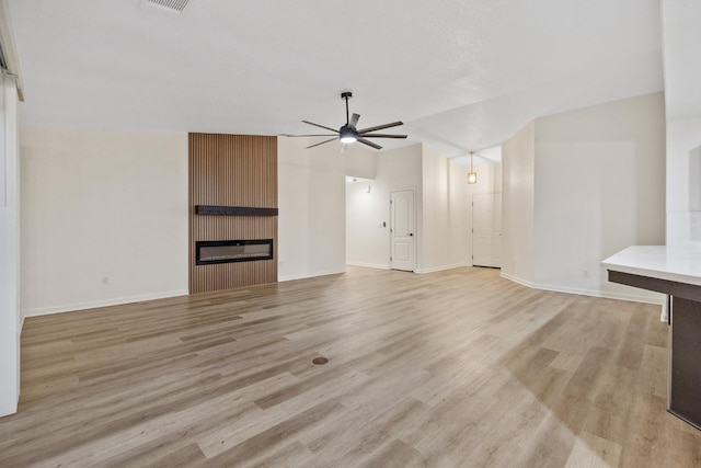 2540 E Seeger Ave, Visalia, CA 93292 - unfurnished living room featuring a ceiling fan, light wood-type flooring, and a large fireplace