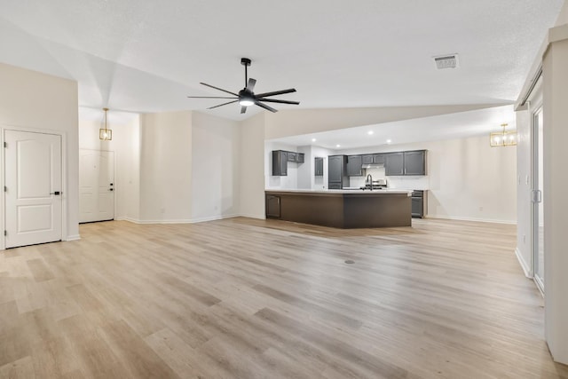 2540 E Seeger Ave, Visalia, CA 93292 - unfurnished living room featuring lofted ceiling, light wood-style floors, ceiling fan, a chandelier, and recessed lighting