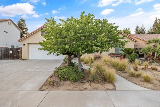 2540 E Seeger Ave, Visalia, CA 93292 - view of front of property with stucco siding, driveway, a tiled roof, and an attached garage