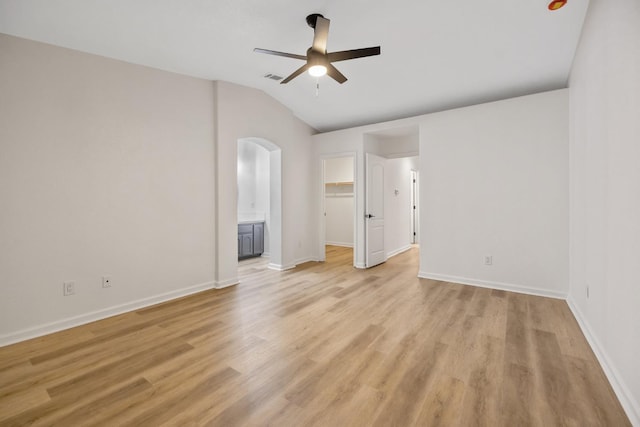 2540 E Seeger Ave, Visalia, CA 93292 - empty room featuring arched walkways, ceiling fan, light wood-type flooring, and lofted ceiling
