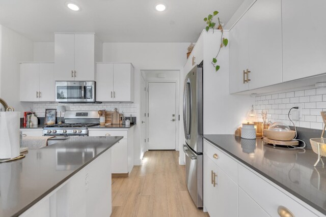 1961 Oak Ln, Clovis, CA 93611 - kitchen with stainless steel appliances, backsplash, dark countertops, white cabinets, and recessed lighting