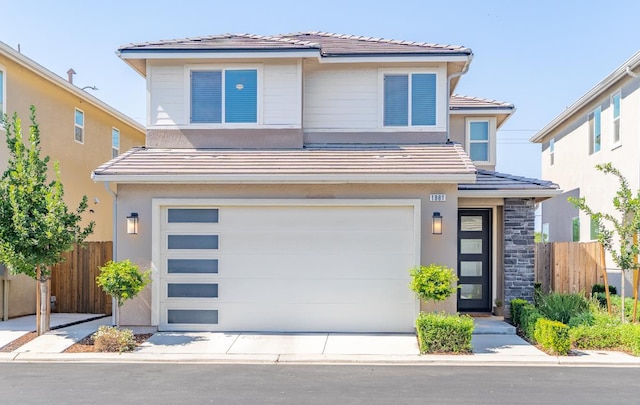 1961 Oak Ln, Clovis, CA 93611 - view of front of property with a garage, a tiled roof, stucco siding, and stone siding