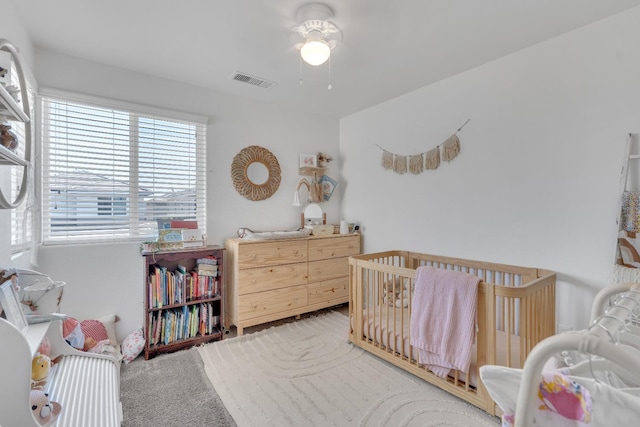 1961 Oak Ln, Clovis, CA 93611 - bedroom featuring a nursery area, light colored carpet, and ceiling fan