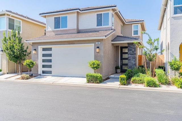 1961 Oak Ln, Clovis, CA 93611 - view of front of home with an attached garage, a tile roof, stucco siding, and concrete driveway