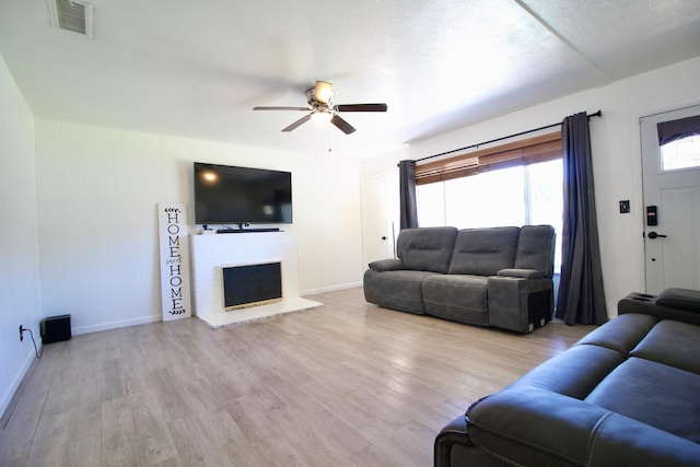 521 Williams Ave, Madera, CA 93637 - living room with ceiling fan, wood finished floors, and a fireplace