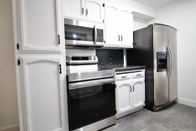 521 Williams Ave, Madera, CA 93637 - kitchen featuring appliances with stainless steel finishes, white cabinetry, decorative backsplash, and tile countertops
