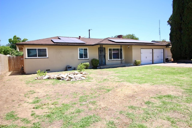 521 Williams Ave, Madera, CA 93637 - ranch-style home featuring stucco siding, a garage, driveway, and solar panels