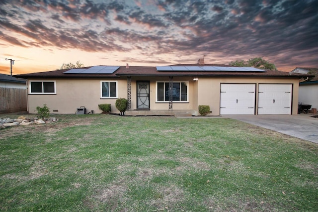 521 Williams Ave, Madera, CA 93637 - ranch-style home featuring stucco siding, a garage, roof mounted solar panels, and concrete driveway