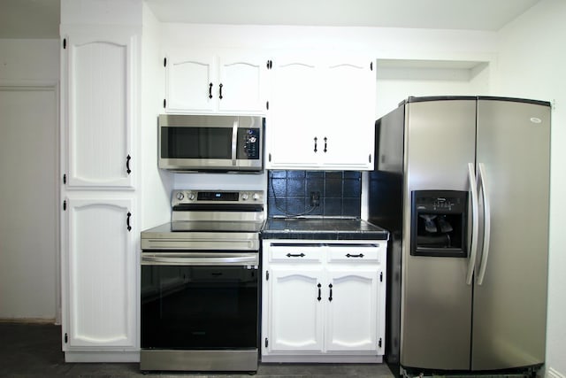 521 Williams Ave, Madera, CA 93637 - kitchen with appliances with stainless steel finishes, white cabinetry, tile counters, and backsplash