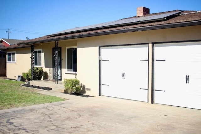 521 Williams Ave, Madera, CA 93637 - view of front of property with stucco siding, concrete driveway, an attached garage, and solar panels