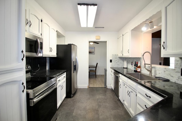 521 Williams Ave, Madera, CA 93637 - kitchen featuring appliances with stainless steel finishes, tasteful backsplash, dark countertops, white cabinets, and a ceiling fan