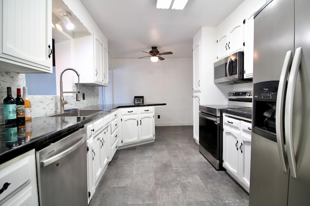 521 Williams Ave, Madera, CA 93637 - kitchen featuring appliances with stainless steel finishes, a peninsula, dark countertops, and a ceiling fan