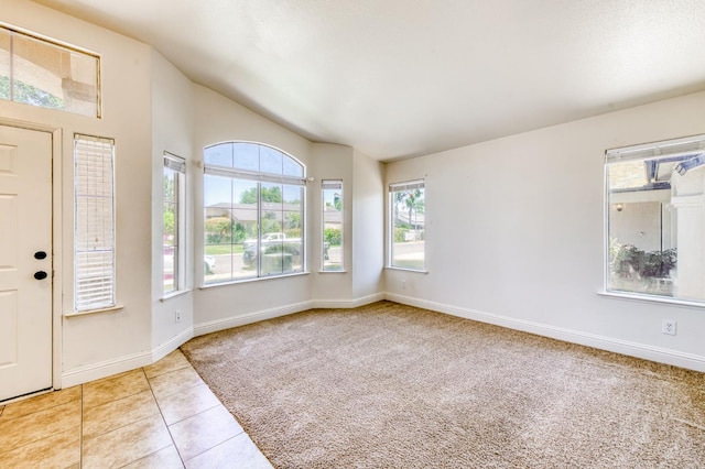 5537 W Oswego Ave, Fresno, CA 93722 - carpeted entryway with lofted ceiling and tile patterned flooring