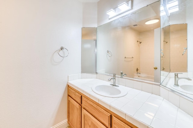 5537 W Oswego Ave, Fresno, CA 93722 - bathroom featuring double vanity and tiled shower / bath